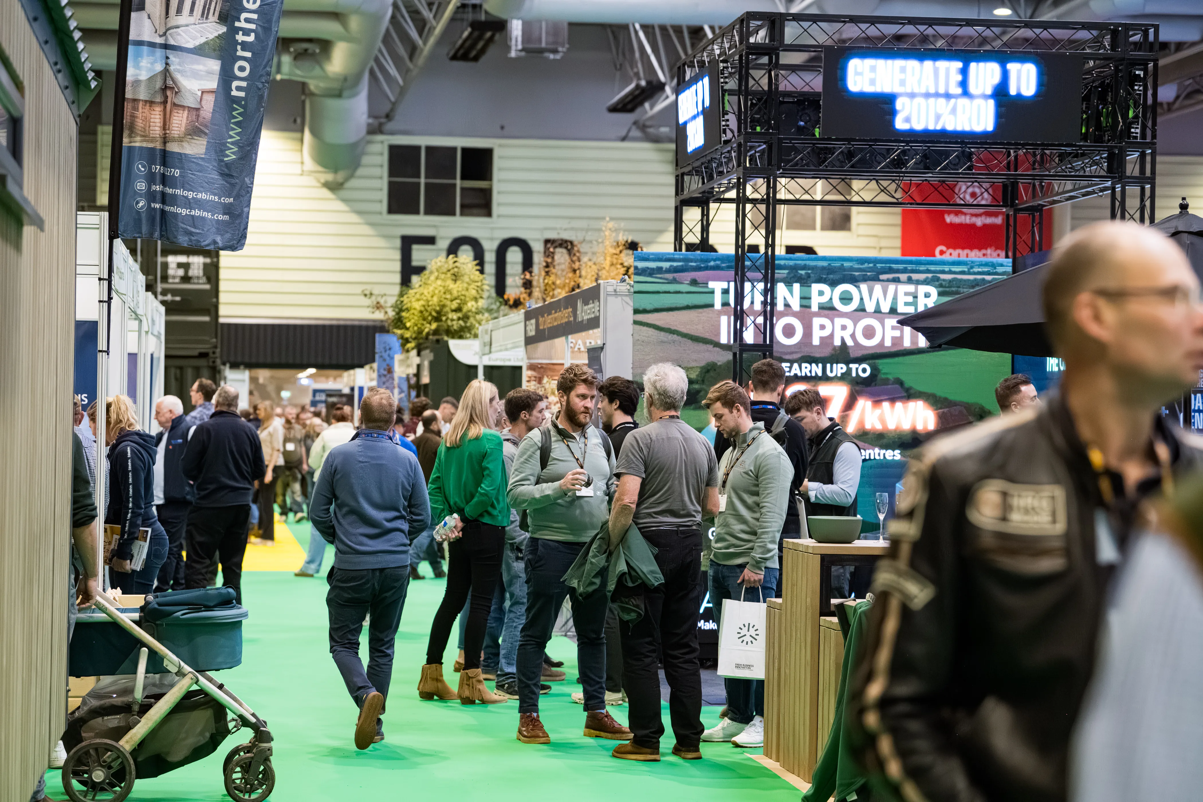 A group of people walking through the exhibition hall.